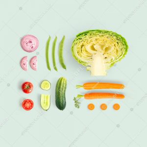 Creative layout made of cucumber, carrot, tomato, onion and cabbage and green beens. Flat lay. Food concept.