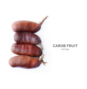 Creative layout made of carob on white background. Flat lay. Food concept.